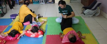 A Cambodian child receives treatment from a Projects Abroad Physiotherapy intern. A Physiotherapy intern works with a young patient at a rehabilitation centre in Cambodia.